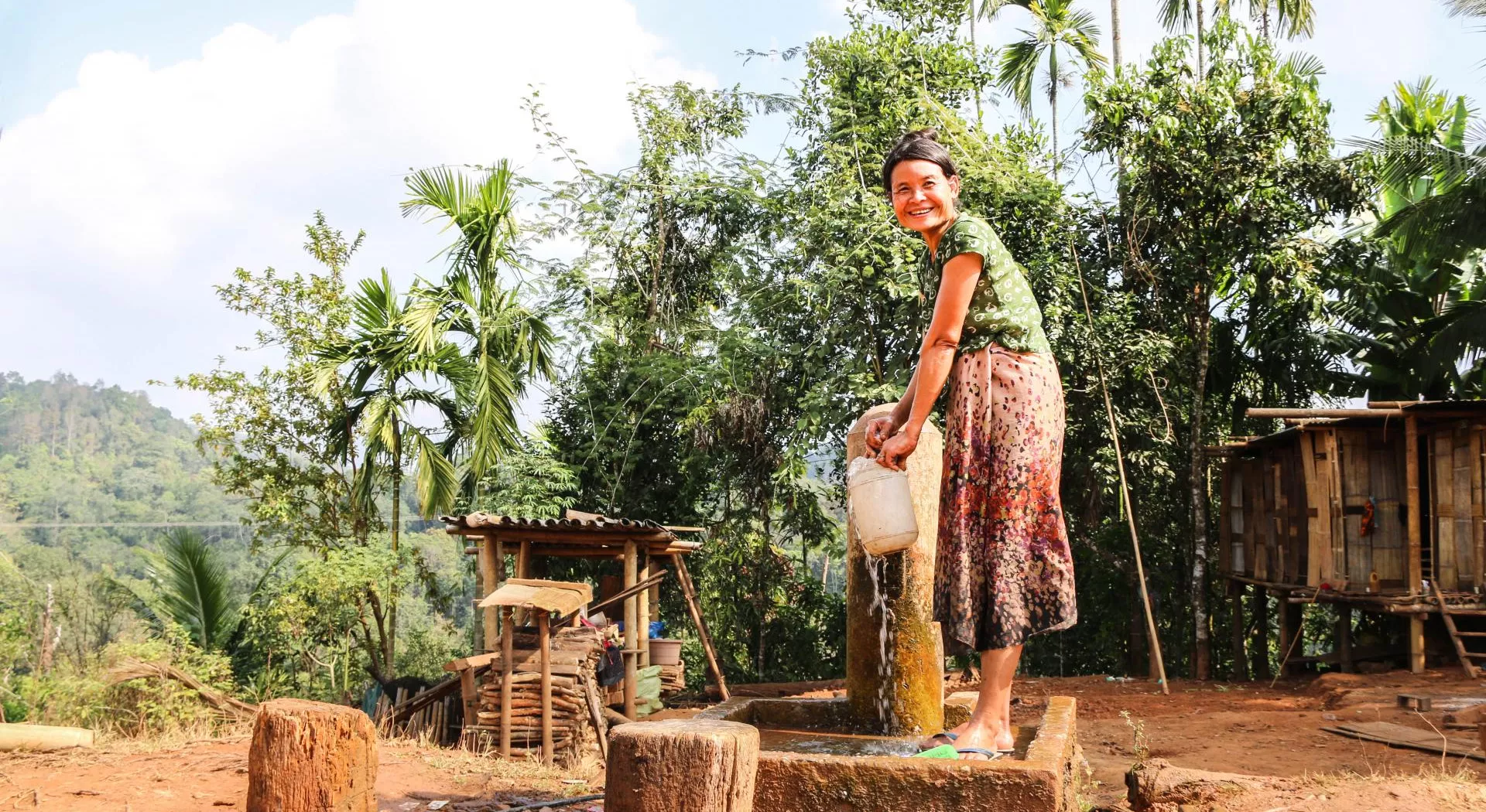 Myanmar: a woman getting water from a pump