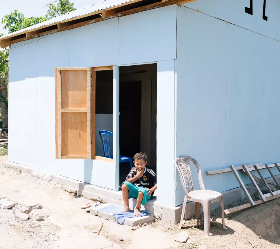 a boy in front of his house 