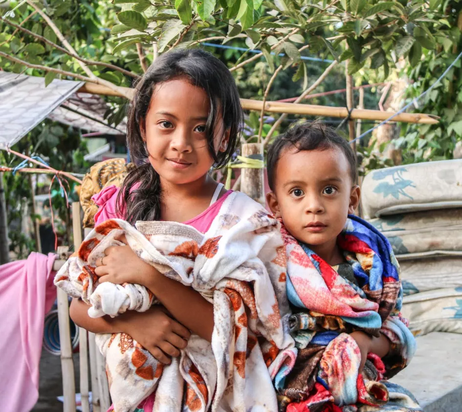 Kinderen met dekens bij distributie Indonesië