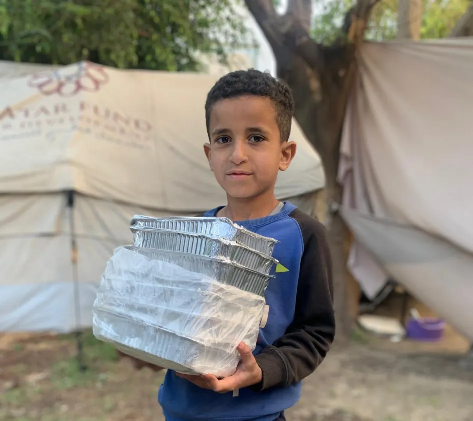 A boy in Gaza receives food