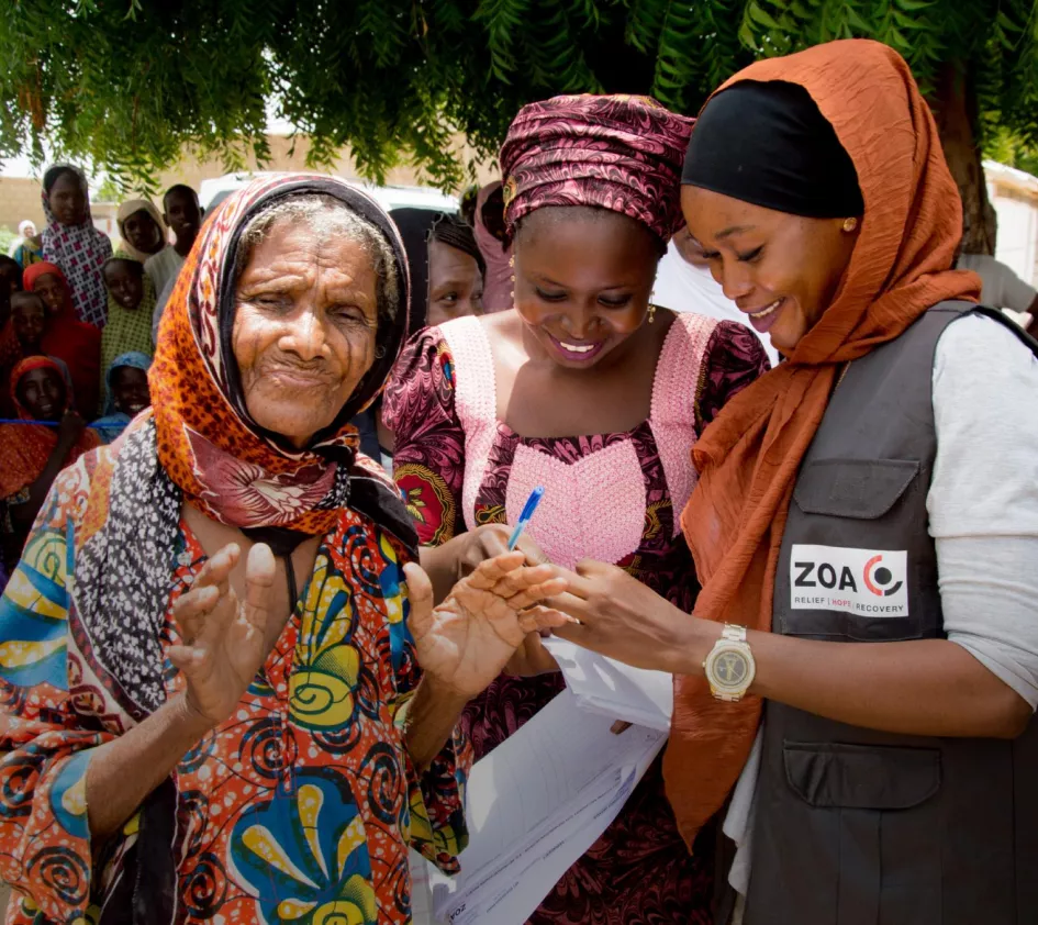 A woman receives cash assistance