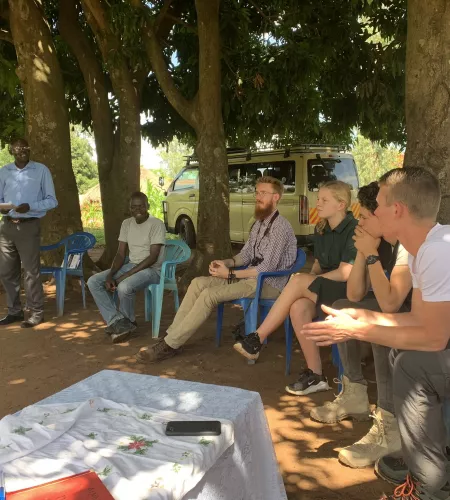 Joppe meeting with team members during a field visit in Uganda