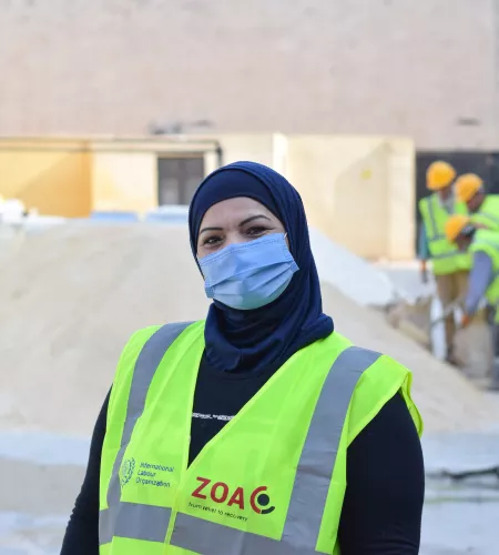 Woman at work in school rehabilitation Syria
