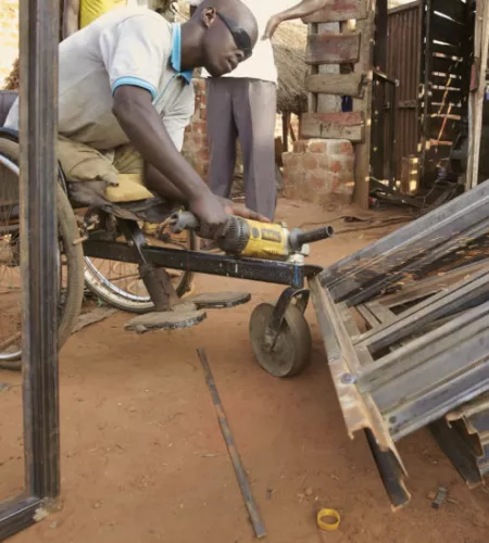 Anaka Oskar Okello is missing his legs, but has a thriving business. Photo: Jaco Klamer
