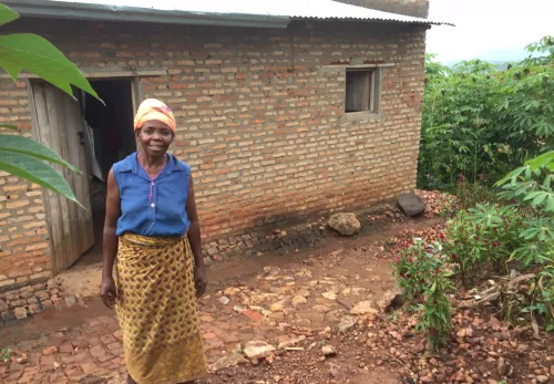 Marie voor haar huis in Burundi
